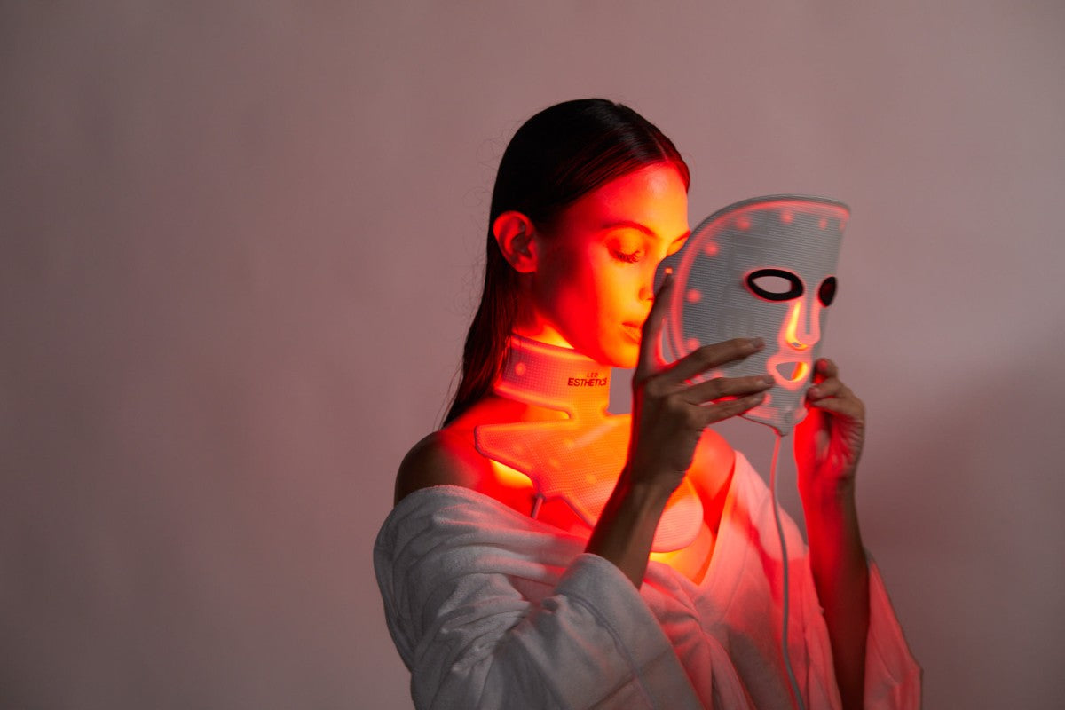 LED Esthetics GloTech™ Pro red light therapy face mask in use, featuring FDA-cleared red, blue, and near-infrared light for anti-aging, collagen stimulation, and skin rejuvenation at home.