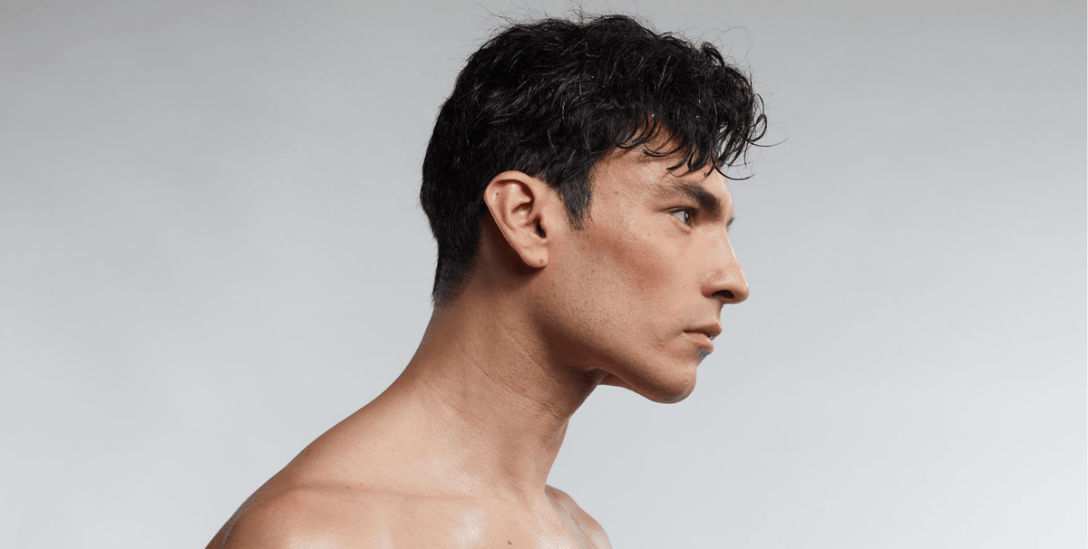 Side profile of man showing clear skin and jawline, representing early results timeline of red light therapy for skin improvement.