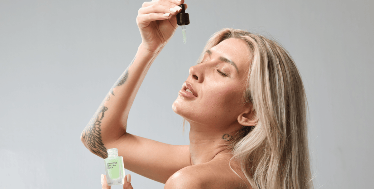 Woman applying serum after LED light therapy, highlighting safe post-treatment skincare to hydrate and support skin recovery.